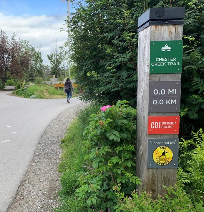 A mile marker trail post along Chester Creek Trail